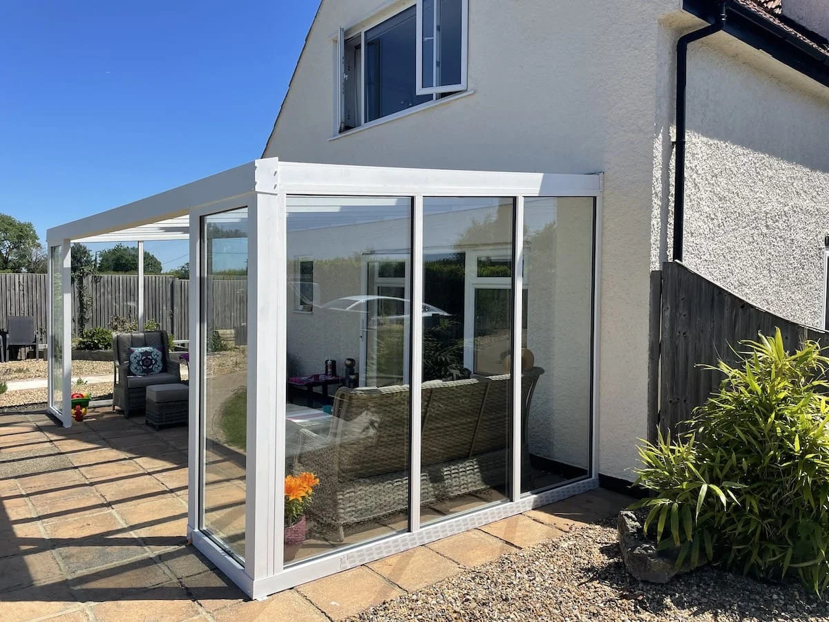 Custom aluminium and glass majlis enclosure with sliding doors installed in Dubai residential property